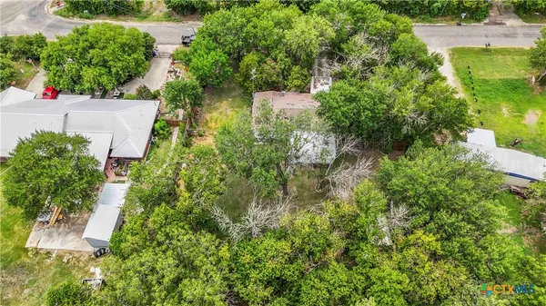 an aerial view of residential house with outdoor space and trees around