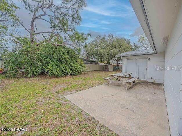 1022 4th Street Port Orange, FL 32129 - Photo 16 of 21 a view of a patio with table and chairs under an umbrella
