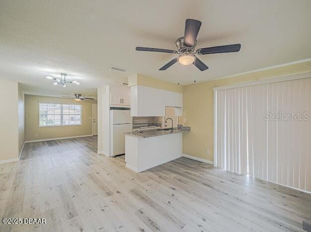 1022 4th Street Port Orange, FL 32129 - Photo 9 of 21 a view of a kitchen with wooden floor and a ceiling fan