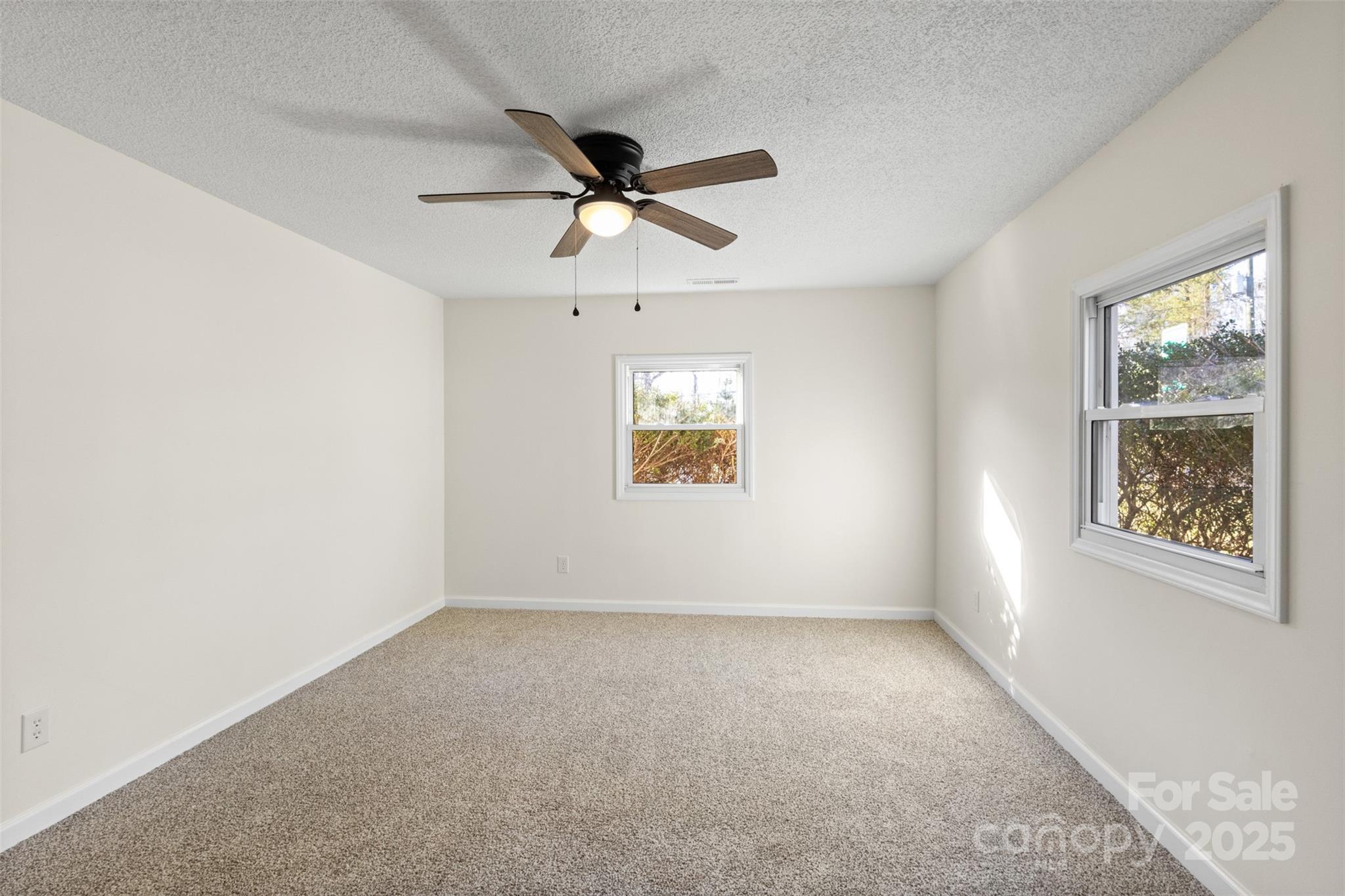 717 Perth Road Troutman, NC 28166 - Photo 12 of 15 an empty room with a window and a ceiling fan