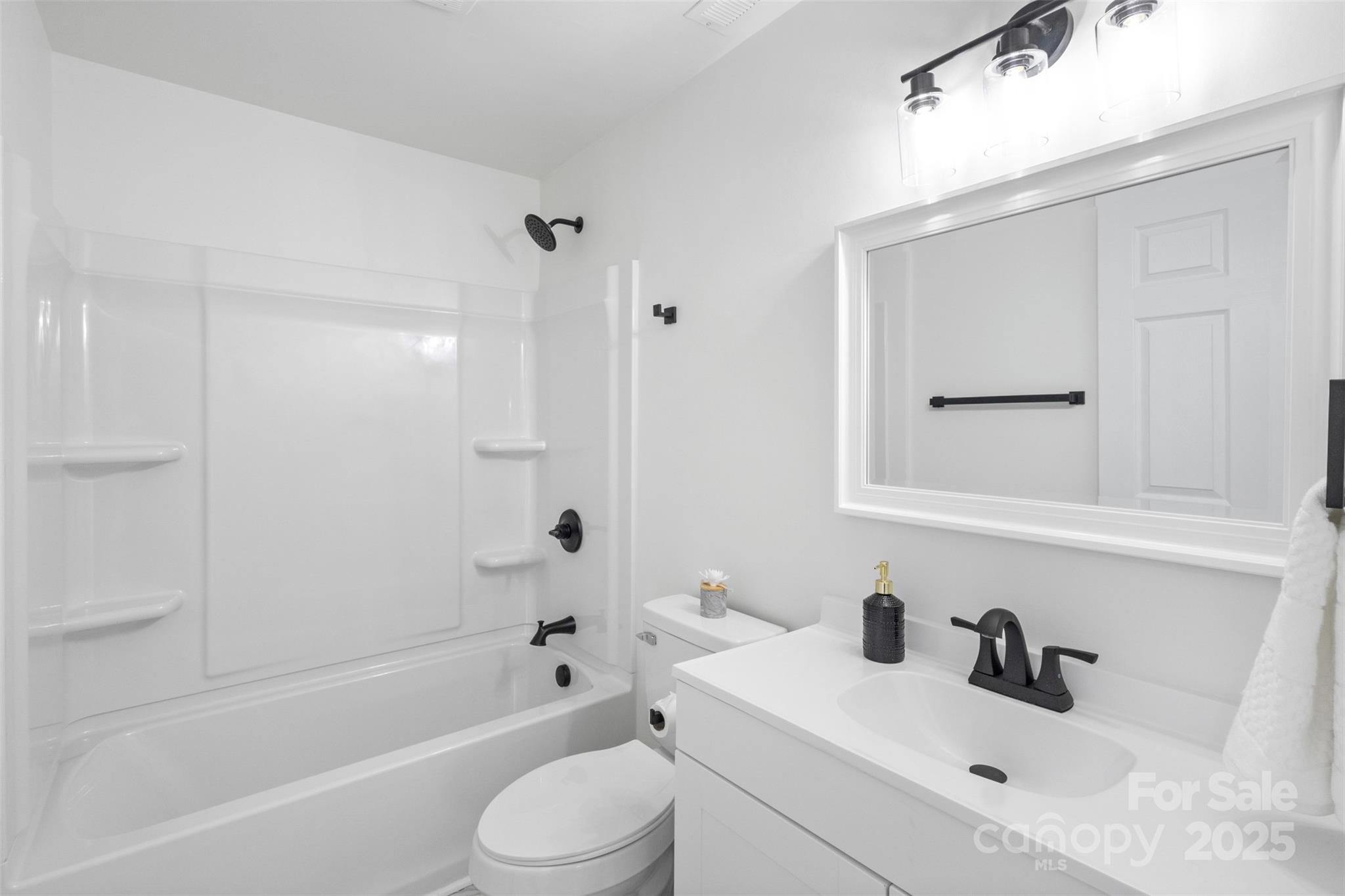 717 Perth Road Troutman, NC 28166 - Photo 13 of 15 a bathroom with a sink a toilet and shower