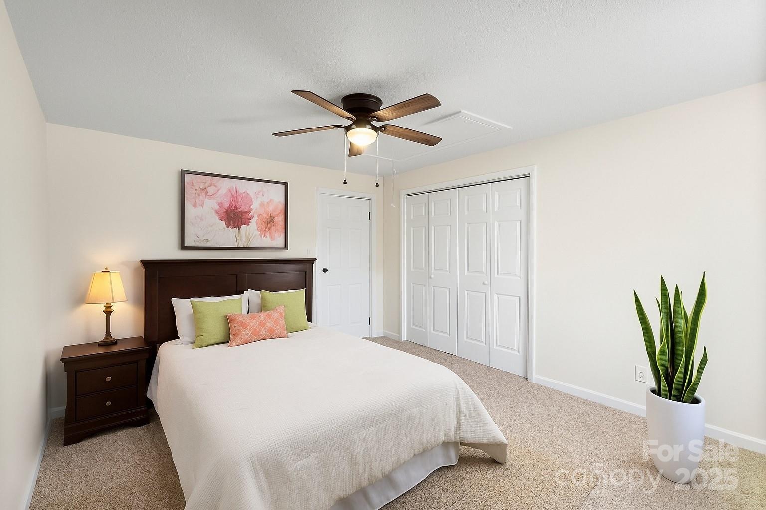 717 Perth Road Troutman, NC 28166 - Photo 8 of 15 a bedroom with a bed and a chandelier