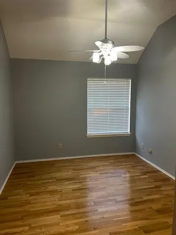 a view of wooden floor and windows in a room