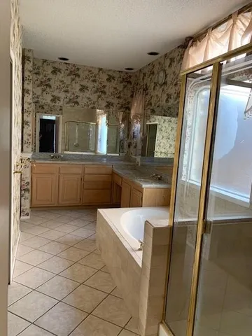 a living room with stainless steel appliances wooden floor and a fireplace