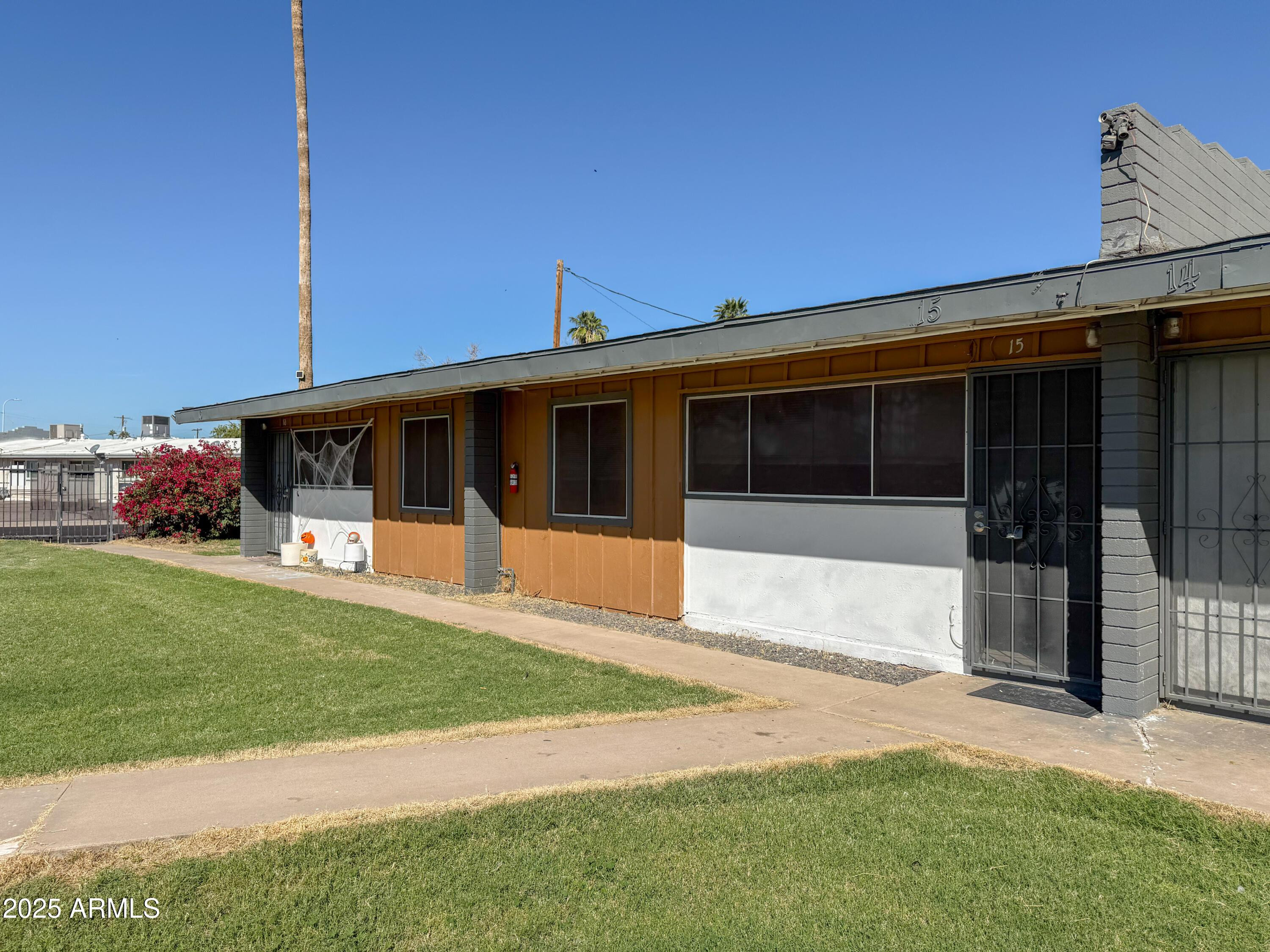 2123 West Devonshire Avenue, Unit 15 Phoenix, AZ 85015 - Photo 3 of 14 a front view of a house with a yard and garage