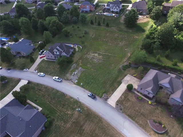 an aerial view of a house with a yard