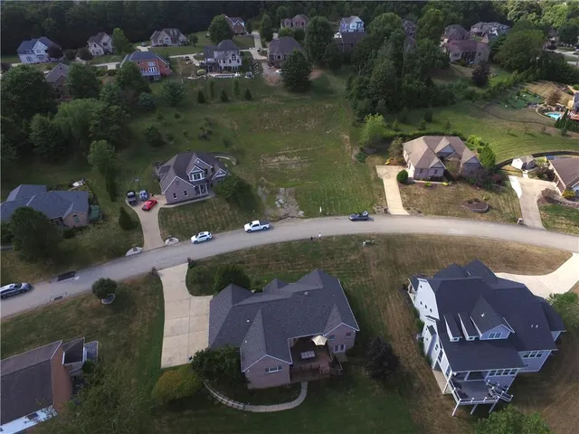 an aerial view of a house with a lake view