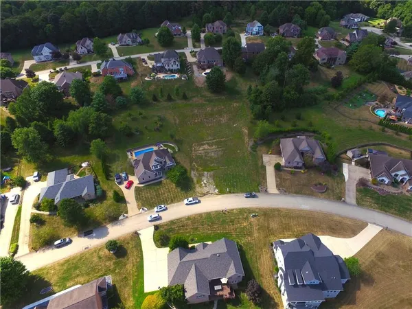 an aerial view of a house with yard swimming pool and outdoor seating