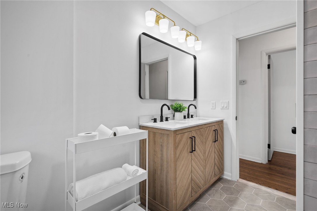 15857 Henley Road Cleveland, OH 44112 - Photo 24 of 42 Bathroom with tile patterned floors, toilet, and vanity