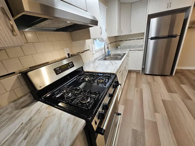 a kitchen with wooden cabinets and a stove top oven