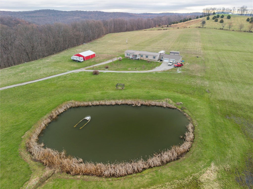 1926 Fairview Road Peebles, OH 45660 - Photo 14 of 44 This expansive rural property features a tranquil pond and ample acreage for outdoor enjoyment.