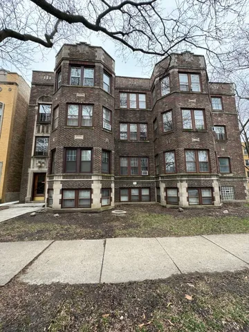 a front view of a residential apartment building with a yard