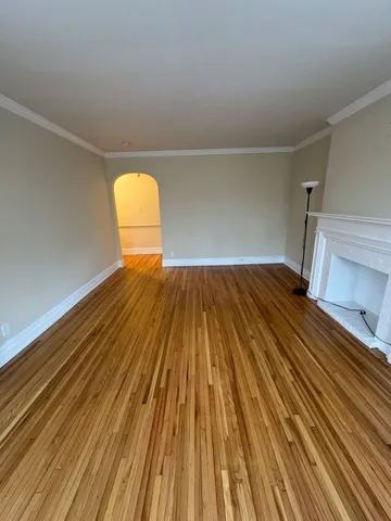 a view of a room with wooden floor