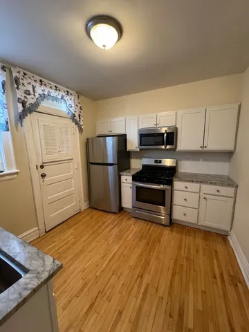 a kitchen with a refrigerator and a stove top oven