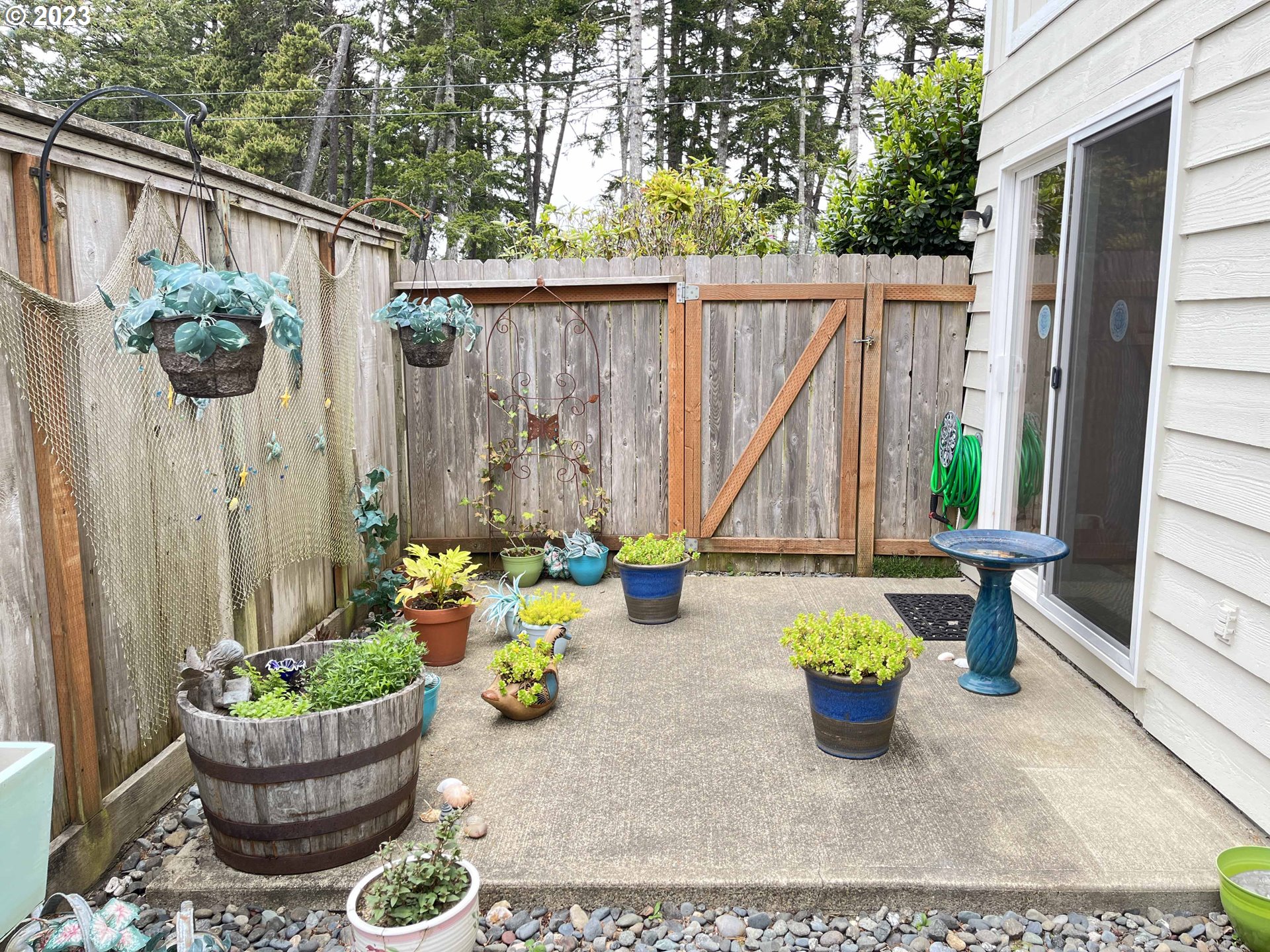 1340 9th Street, Unit 4 Florence, OR 97439 - Photo 18 of 31 a view of a chair and table in backyard of the house