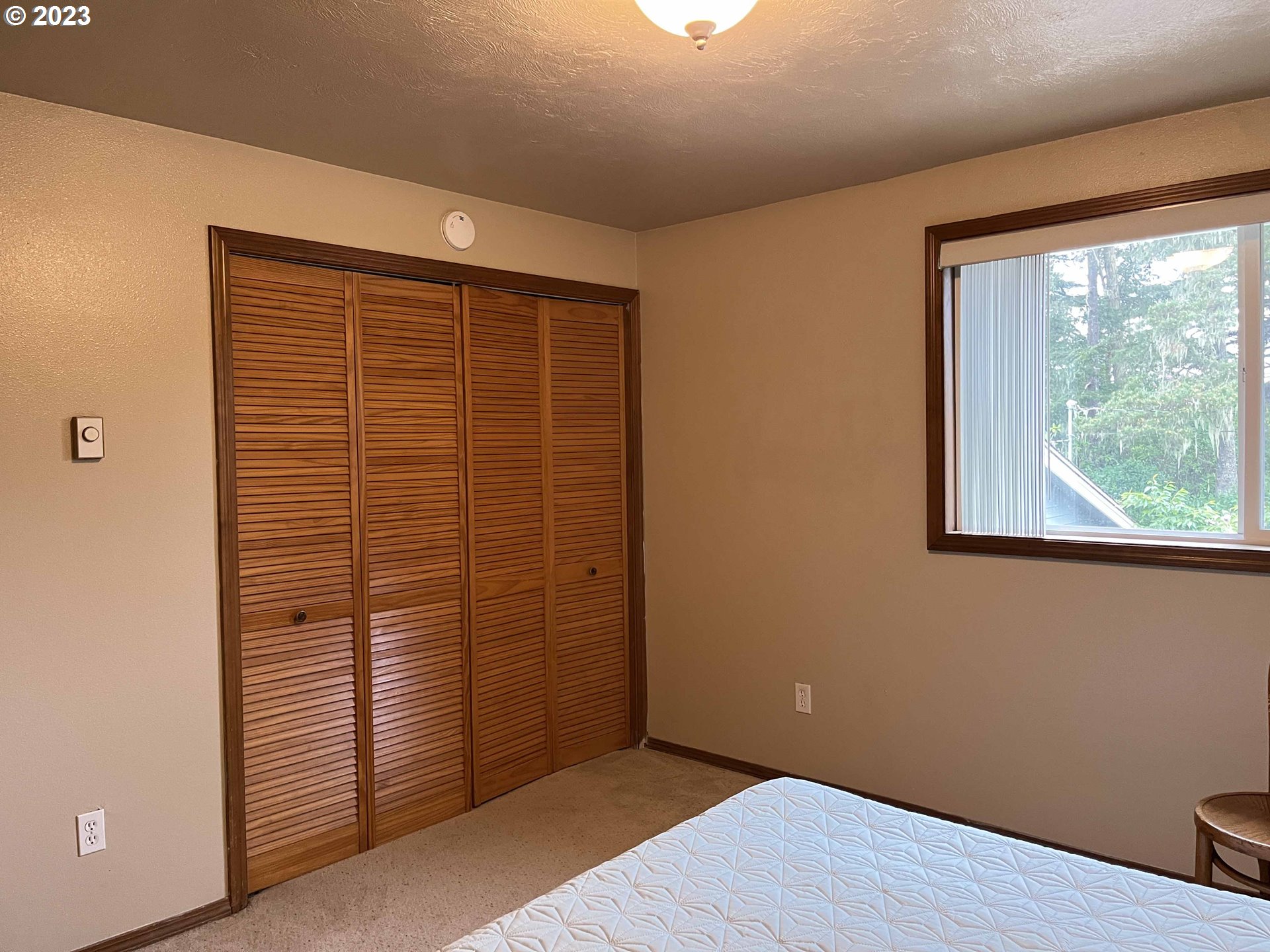 1340 9th Street, Unit 4 Florence, OR 97439 - Photo 23 of 31 an empty room with wooden floor and windows