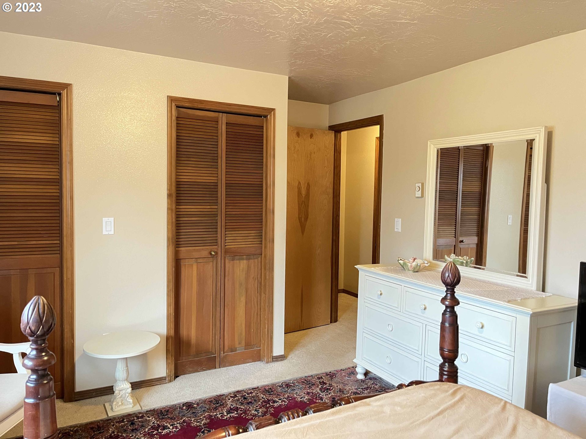 1340 9th Street, Unit 4 Florence, OR 97439 - Photo 26 of 31 a bedroom with a bed and wooden floor