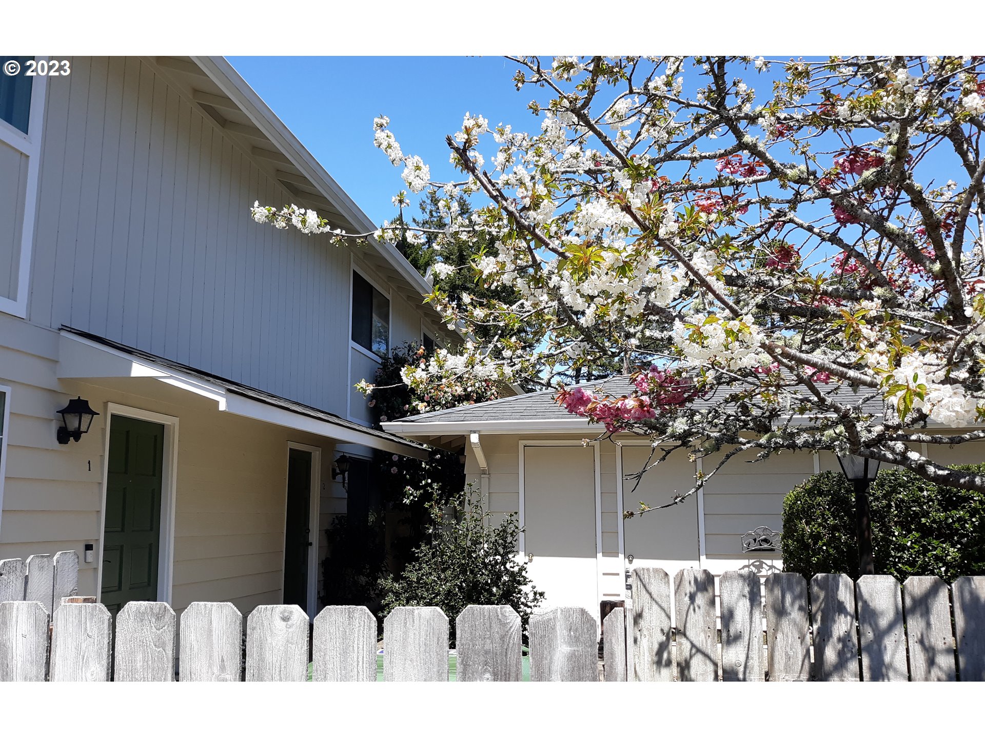 1340 9th Street, Unit 4 Florence, OR 97439 - Photo 29 of 31 a view of a house with a tree