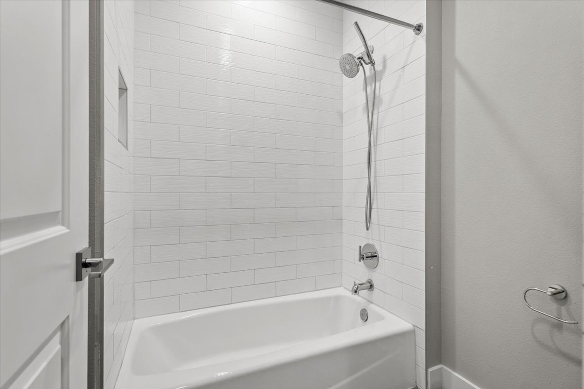 913 Stobaugh Street, Unit B Austin, TX 78757 - Photo 35 of 40 Clean lines and subway tile create a fresh and inviting bath space.