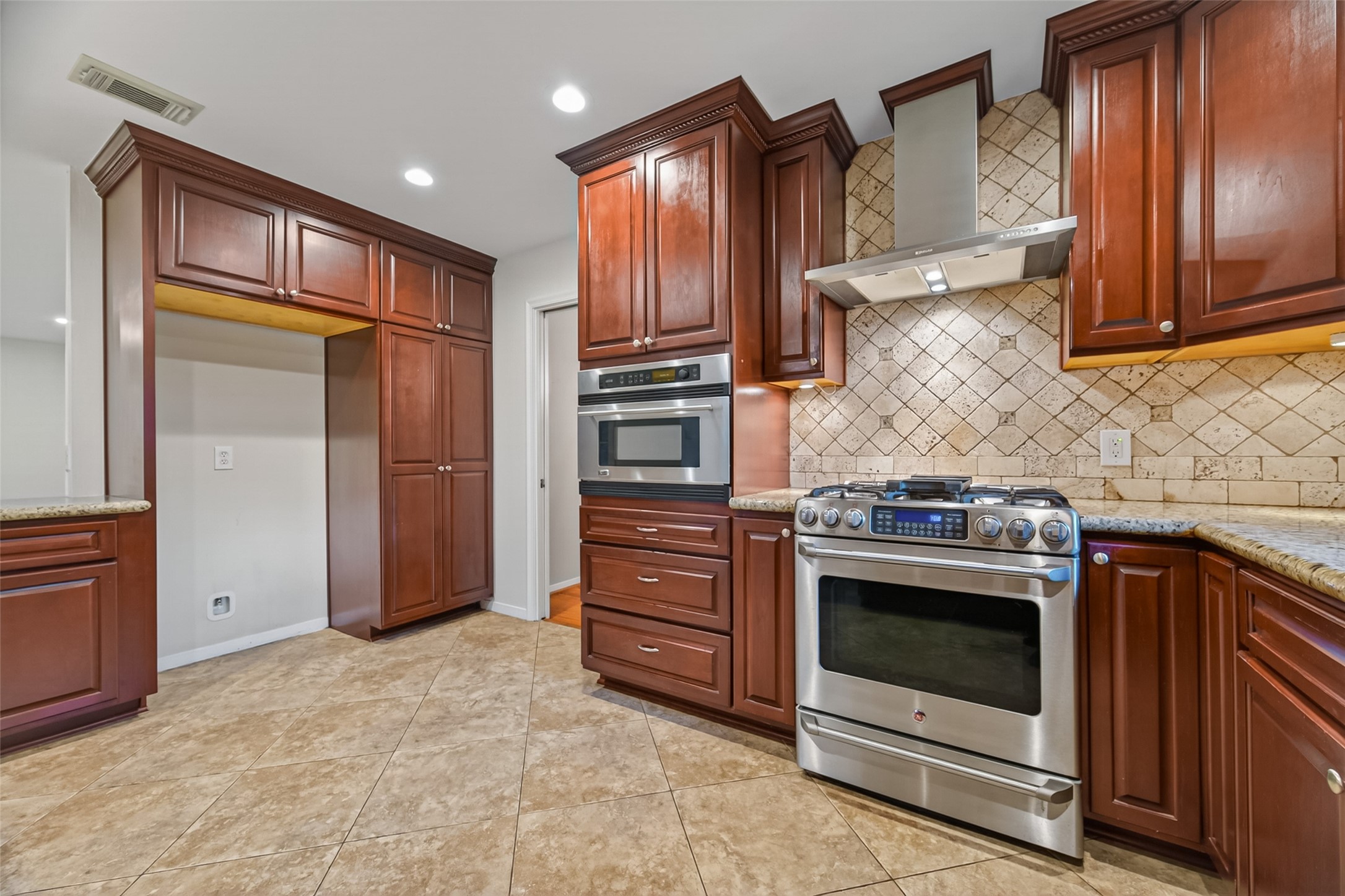5638 Sanford Road Houston, TX 77096 - Photo 13 of 41 Timeless kitchen with classic updates, featuring a GE Monogram Advantium speed oven that functions as a microwave, convection oven, and utilizes halogen light technology for speed cooking.