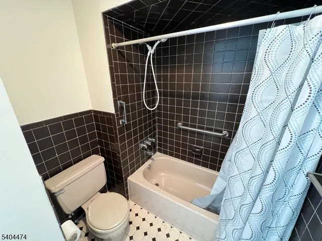 a bathroom with a toilet a sink and bathtub