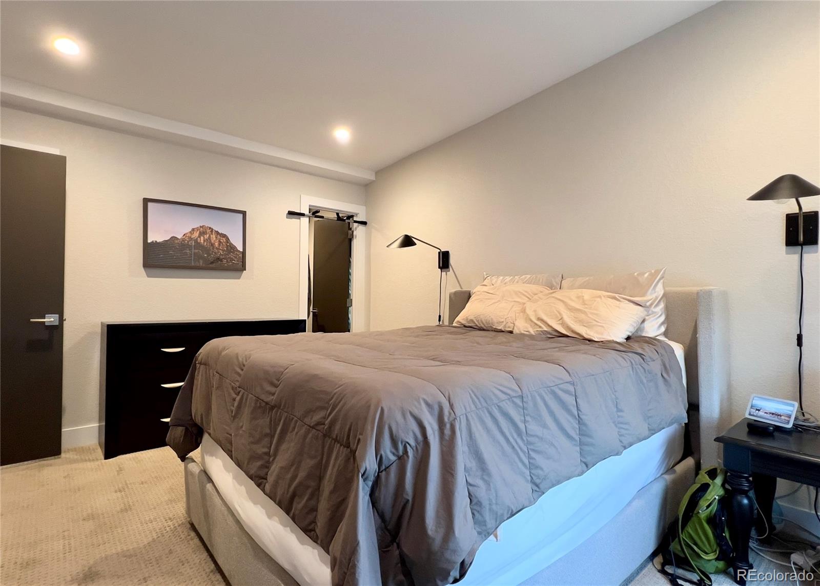 6228 West 38th Avenue Wheat Ridge, CO 80033 - Photo 19 of 38 a bedroom with a bed and a painting on the wall