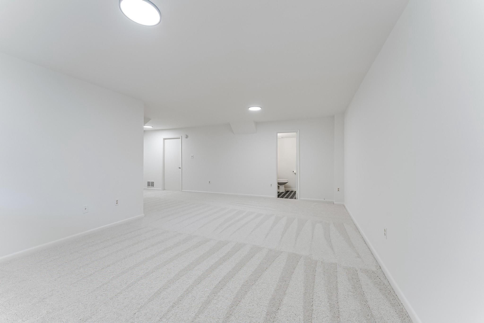 12023 Insha Court Reston, VA 20191 - Photo 9 of 52 a view of an empty room with wooden floor and windows