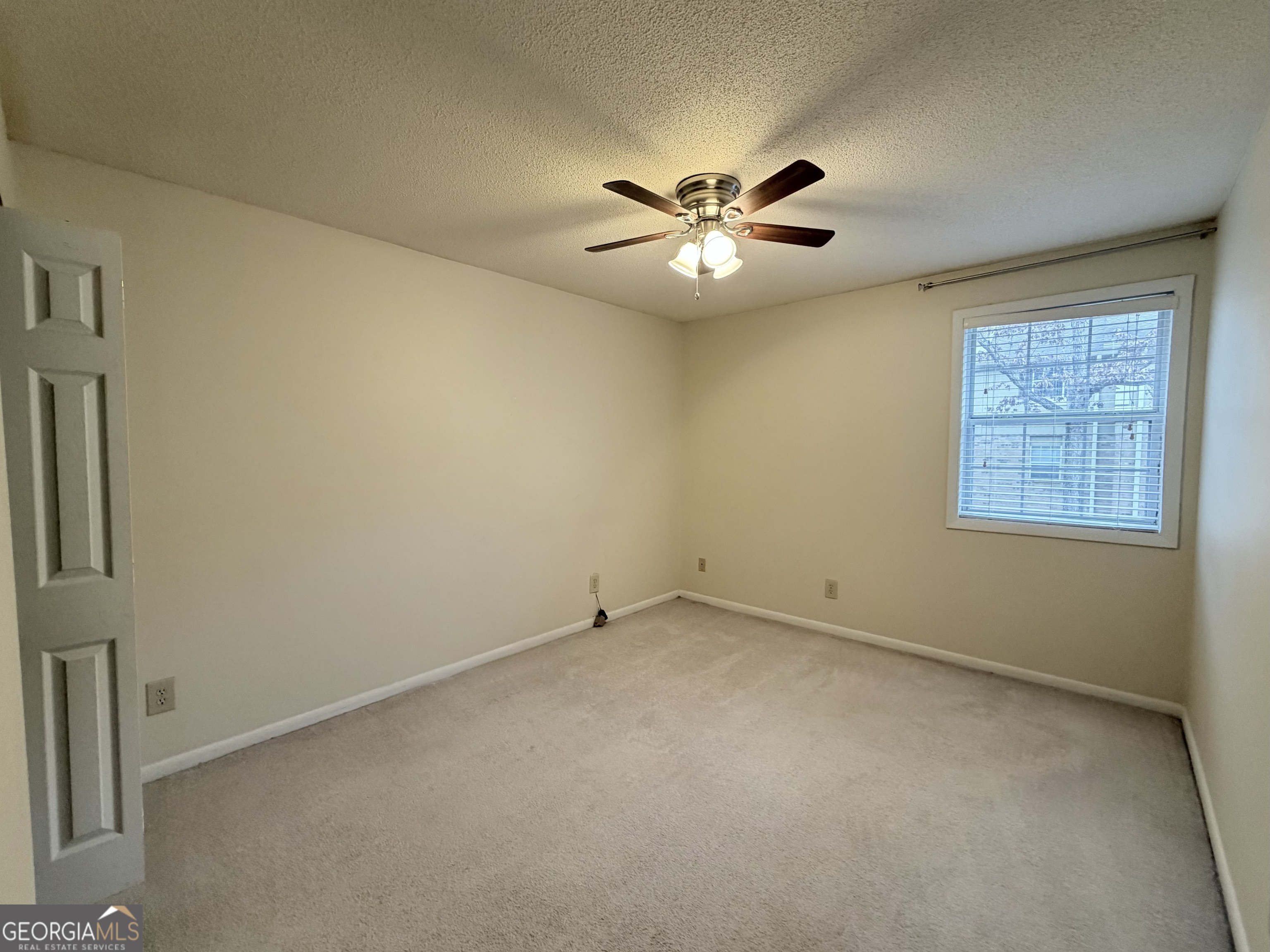 6900 Roswell Road Atlanta, GA 30328 - Photo 12 of 19 an empty room with a window and a fan