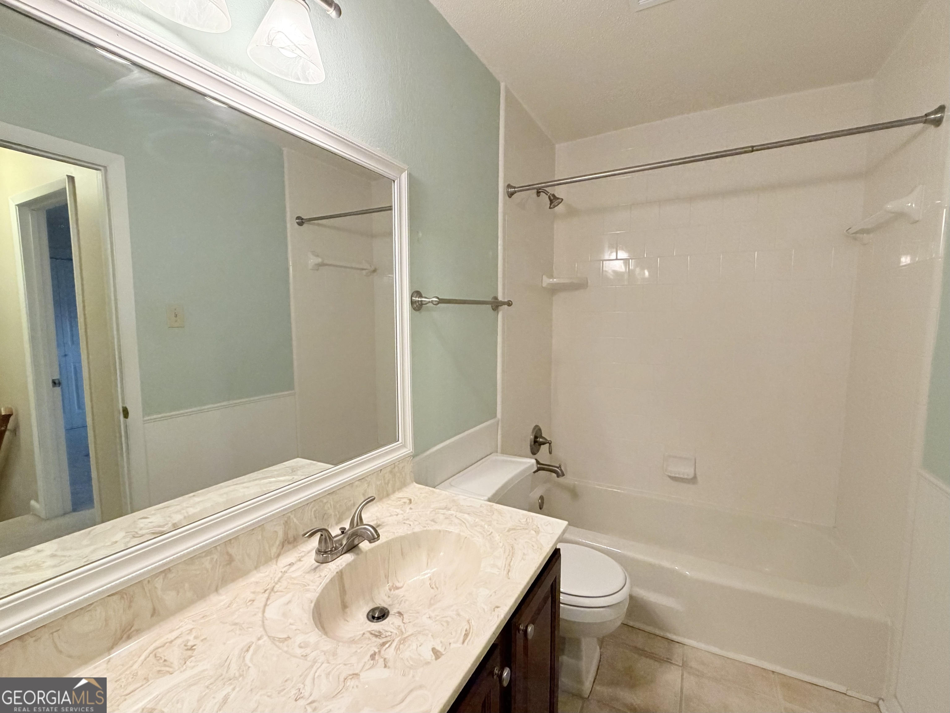 6900 Roswell Road Atlanta, GA 30328 - Photo 16 of 19 a bathroom with a sink a toilet and shower