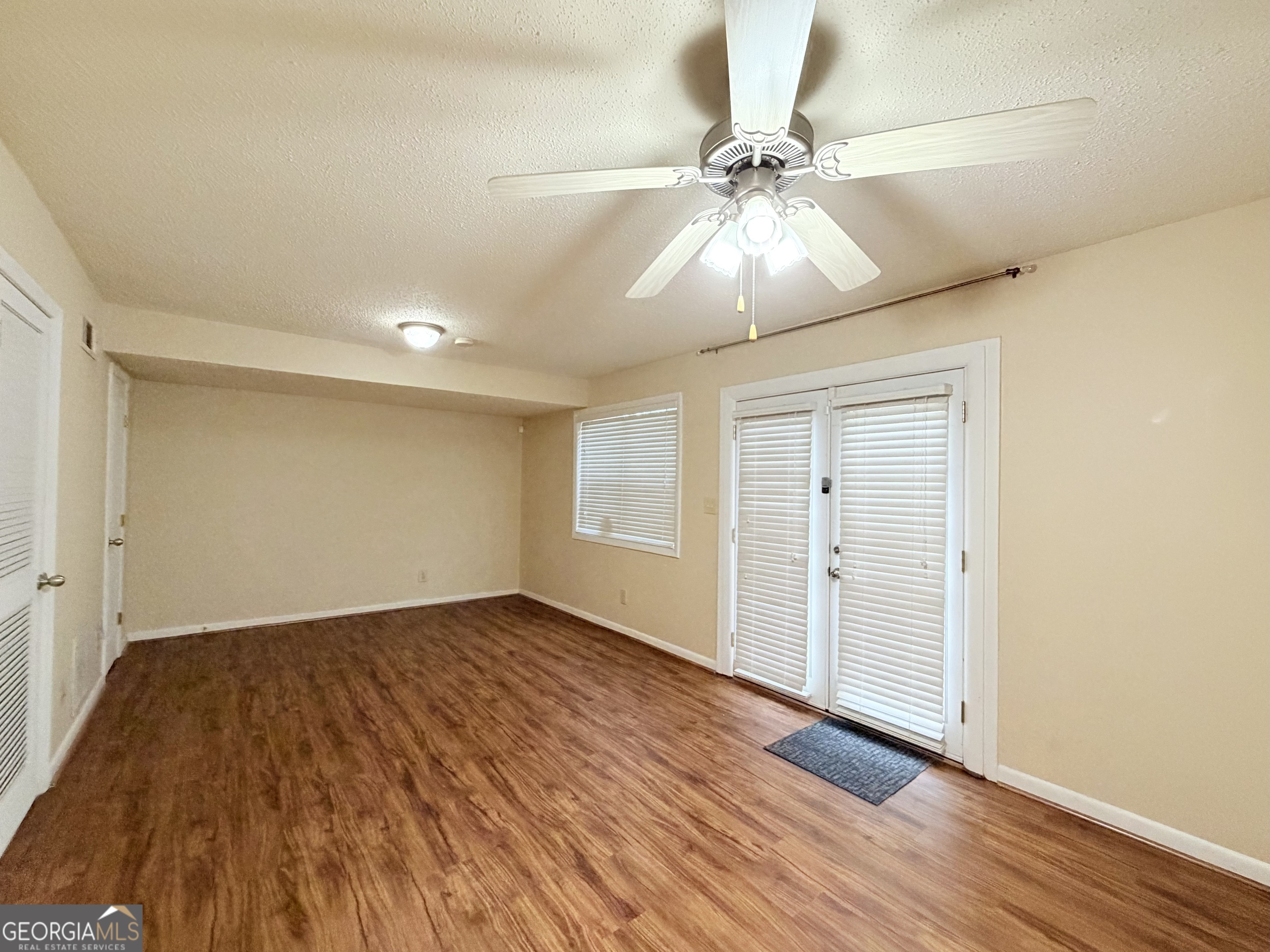 6900 Roswell Road Atlanta, GA 30328 - Photo 17 of 19 an empty room with wooden floor closet and fan