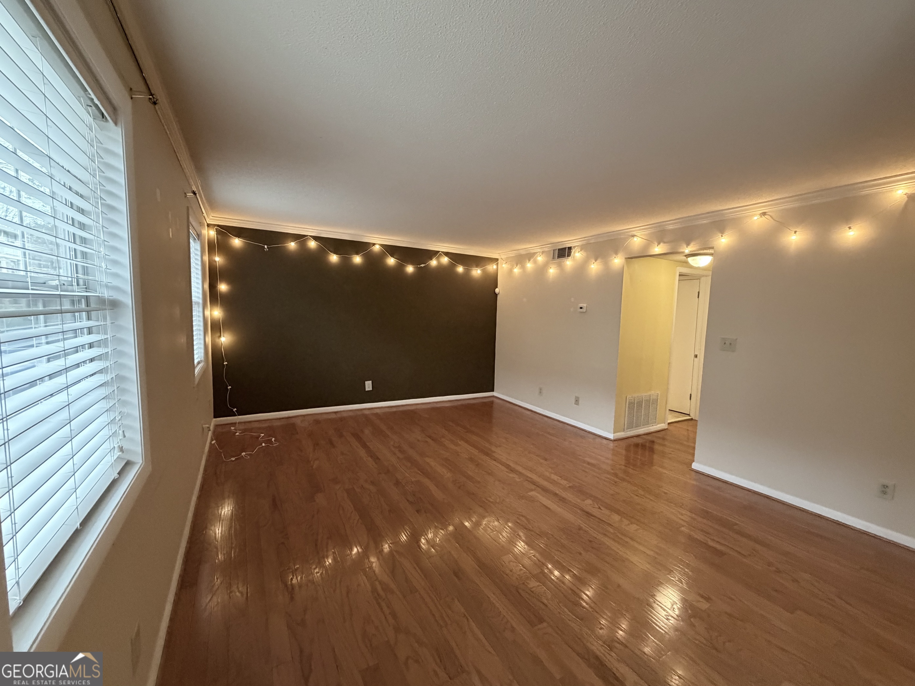 6900 Roswell Road Atlanta, GA 30328 - Photo 2 of 19 a view of empty room with wooden floor