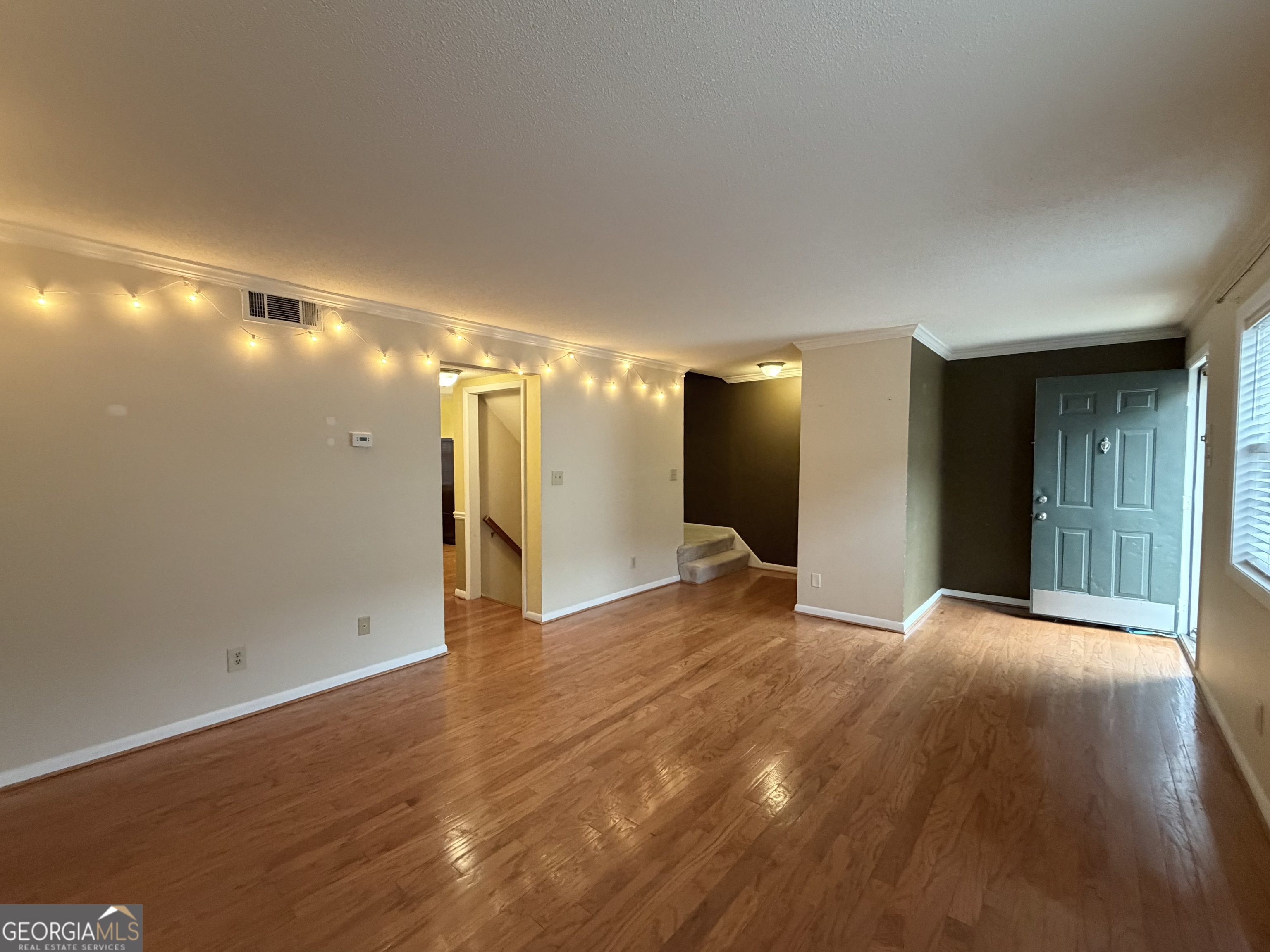 6900 Roswell Road Atlanta, GA 30328 - Photo 3 of 19 a view of an empty room with wooden floor