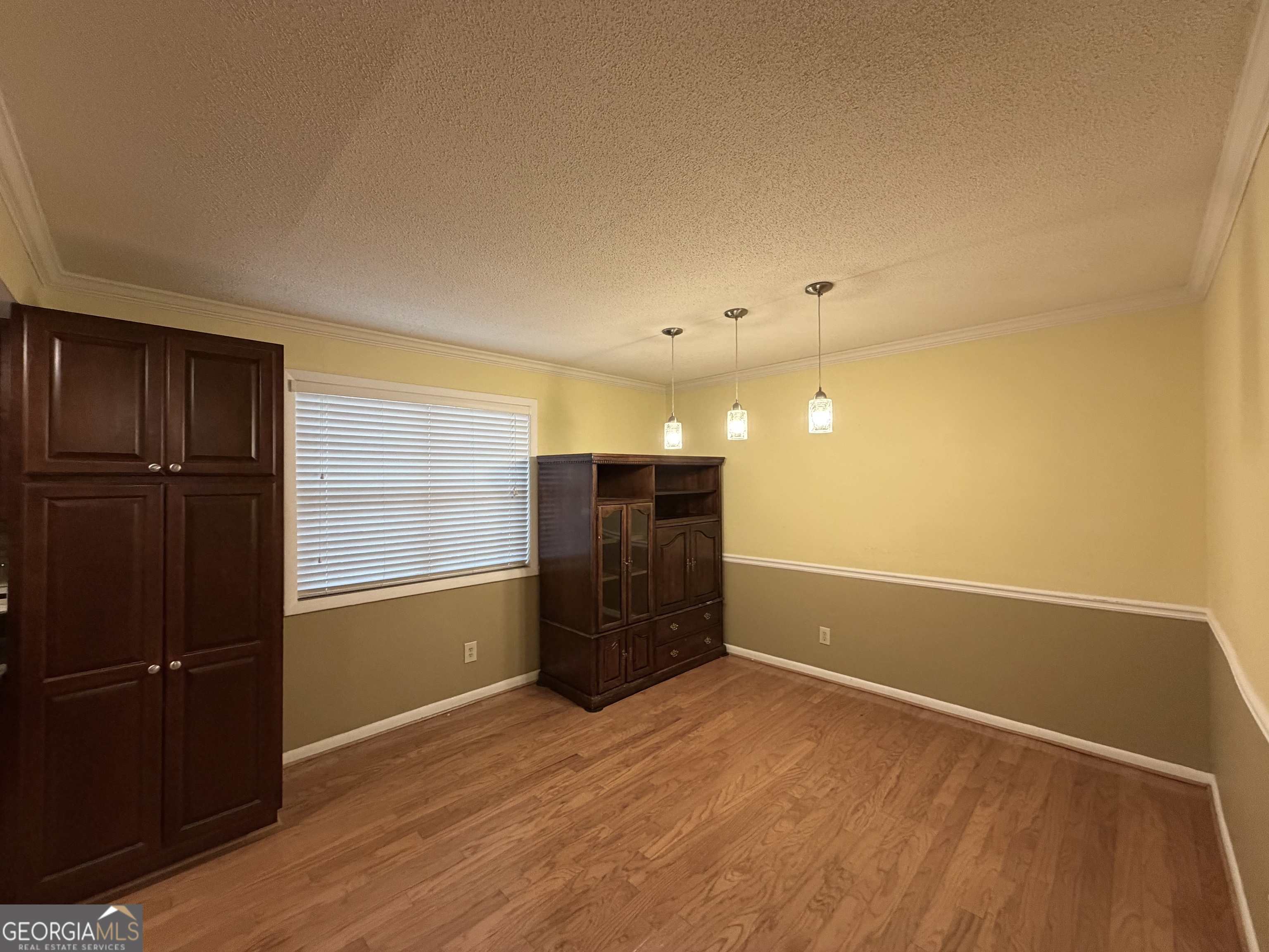 6900 Roswell Road Atlanta, GA 30328 - Photo 4 of 19 a view of empty room with wooden floor and cabinet