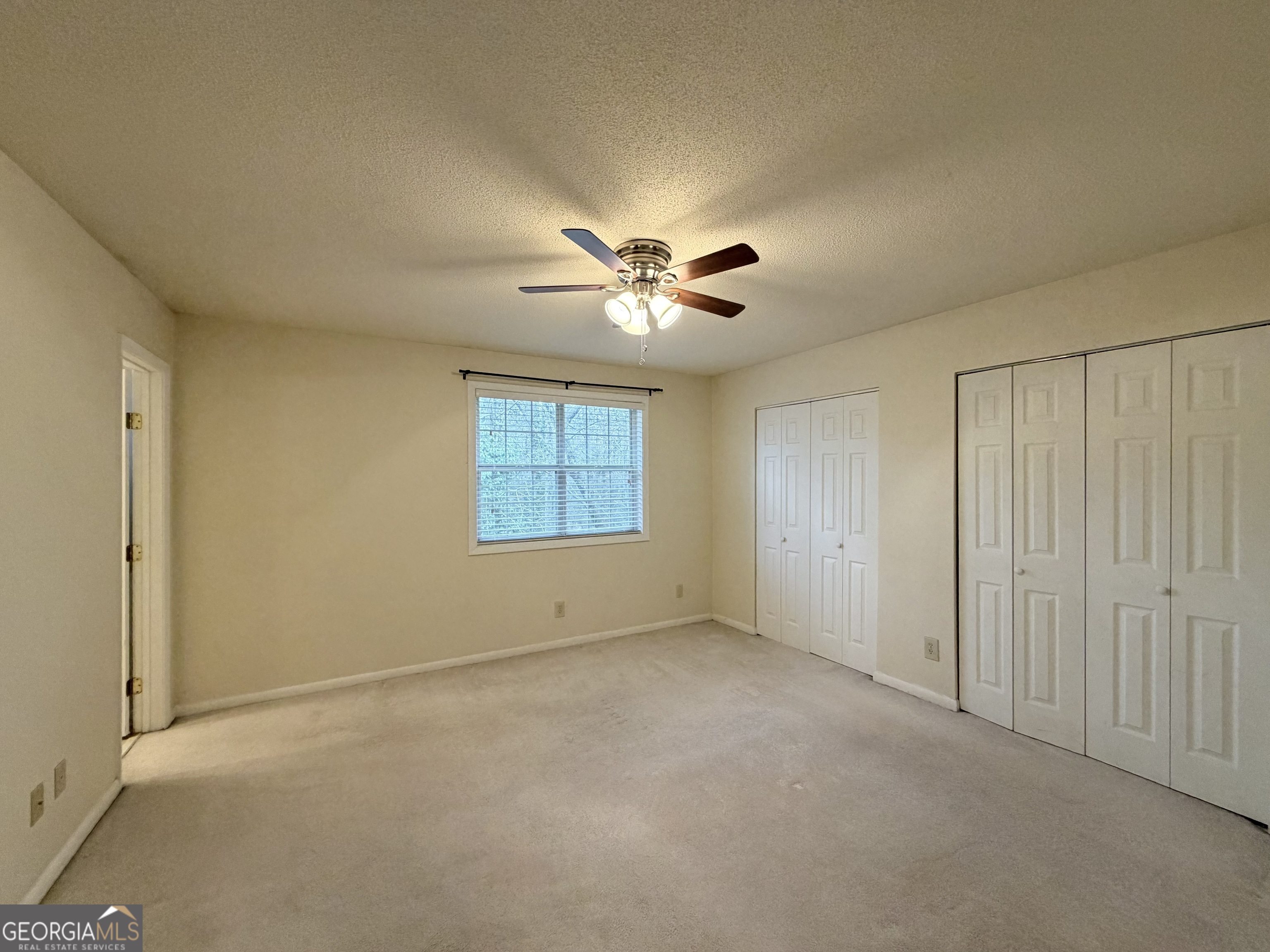 6900 Roswell Road Atlanta, GA 30328 - Photo 9 of 19 an empty room with windows and fan