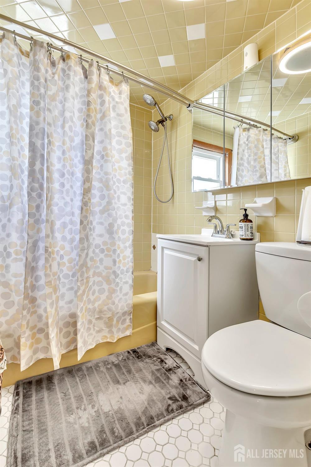 123 Highfield Road Colonia, NJ 07067 - Photo 13 of 30 a bathroom with a sink a toilet and shower curtain