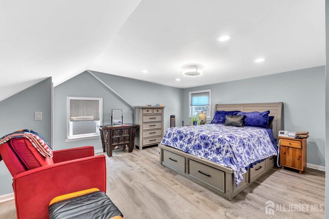 123 Highfield Road Colonia, NJ 07067 - Photo 17 of 30 a spacious bedroom with a bed and wooden floor