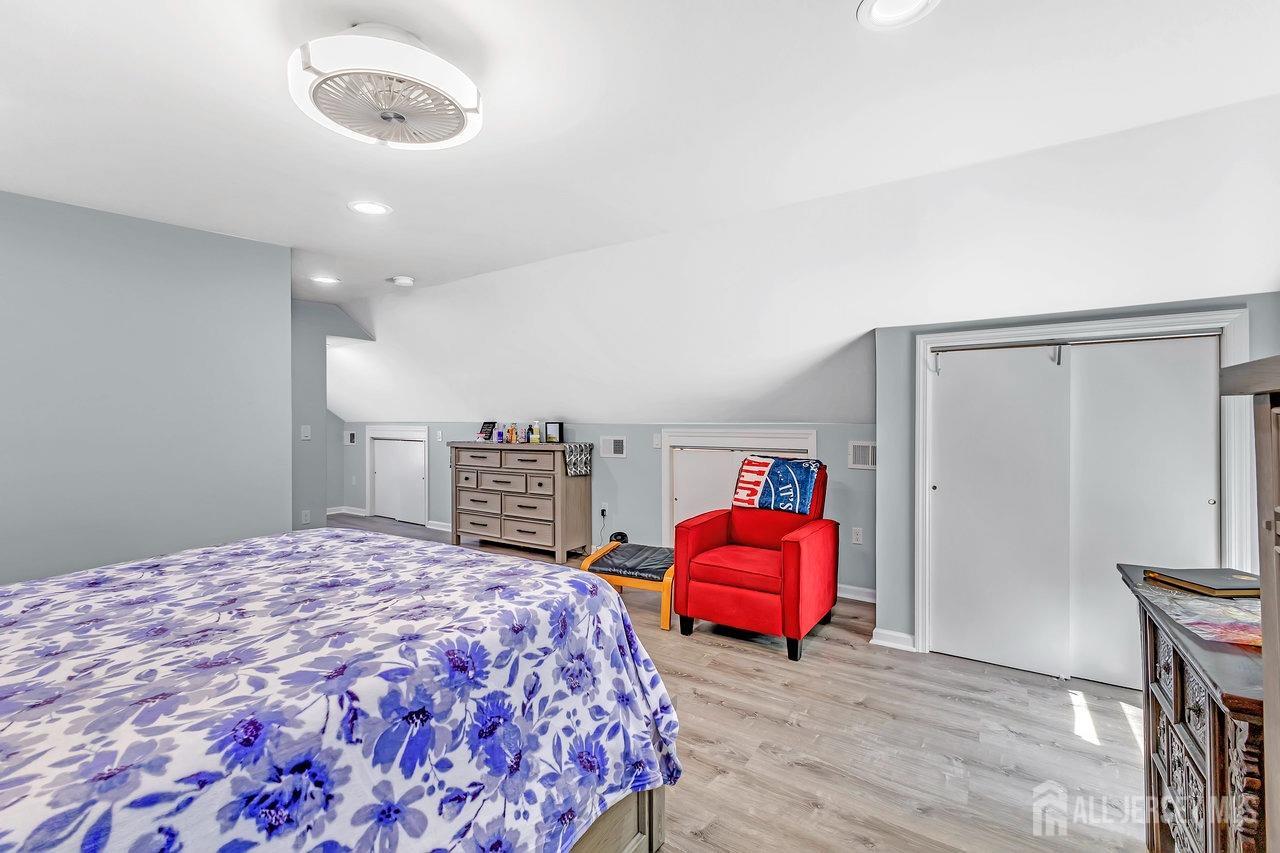 123 Highfield Road Colonia, NJ 07067 - Photo 20 of 30 a spacious bedroom with a bed and a chair
