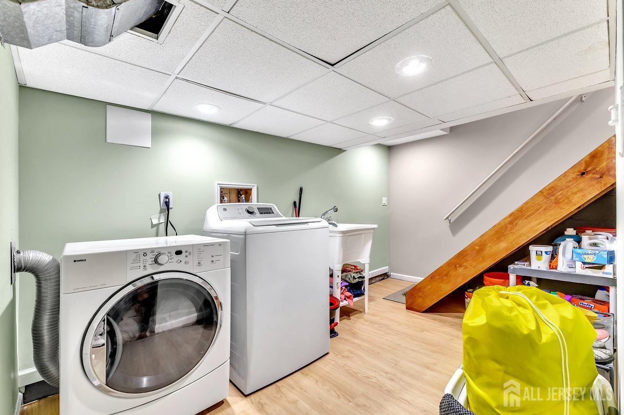 123 Highfield Road Colonia, NJ 07067 - Photo 23 of 30 a view of a storage & utility room with washer and dryer