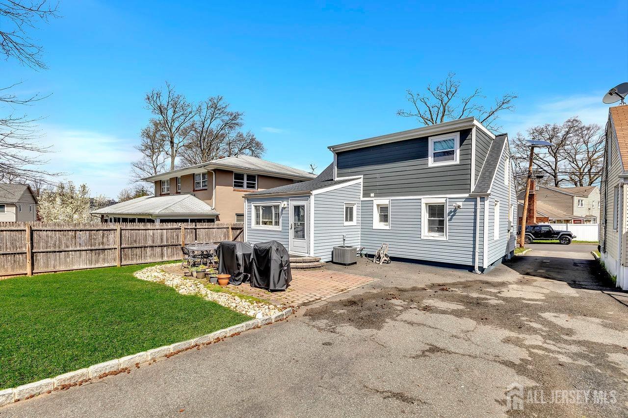 123 Highfield Road Colonia, NJ 07067 - Photo 26 of 30 a front view of a house with a yard table and chairs