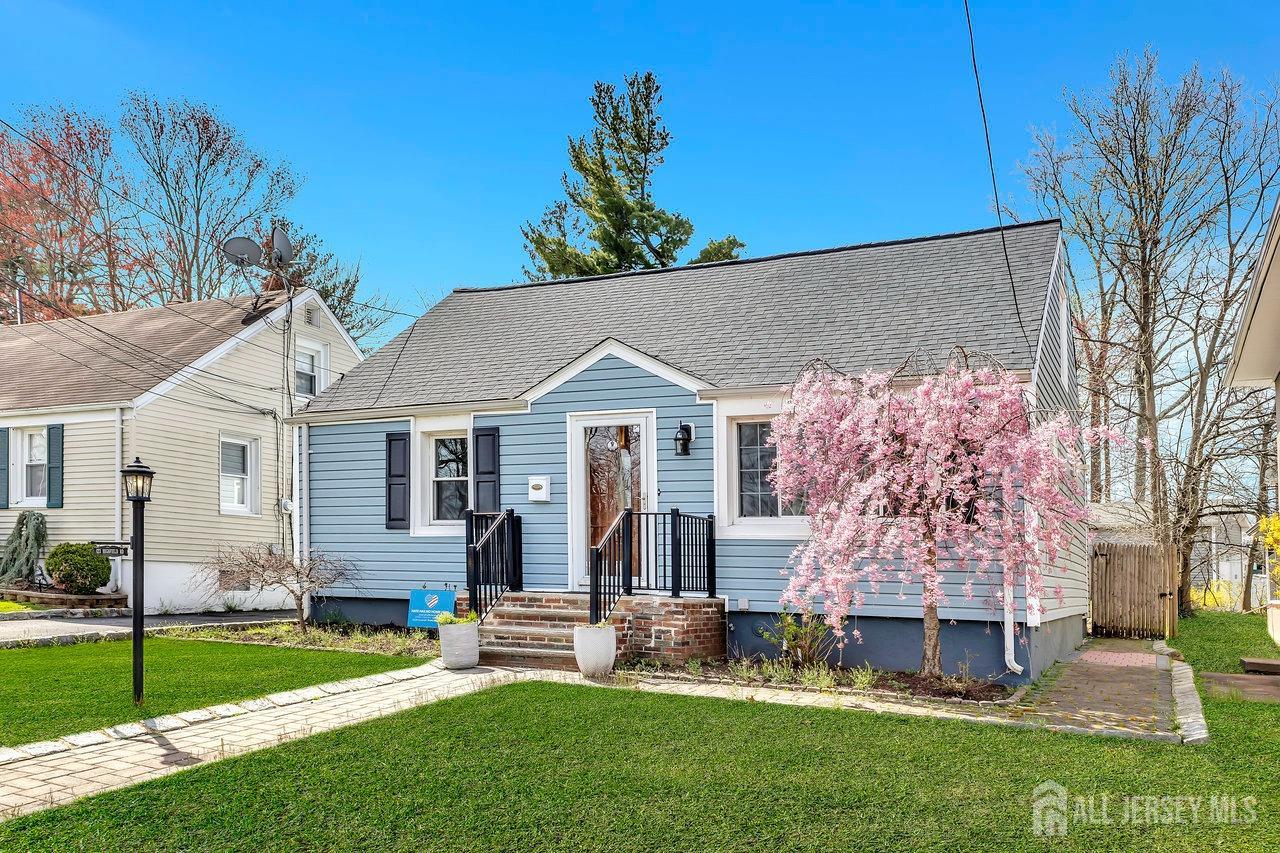 123 Highfield Road Colonia, NJ 07067 - Photo 3 of 30 a front view of house with a garden and patio