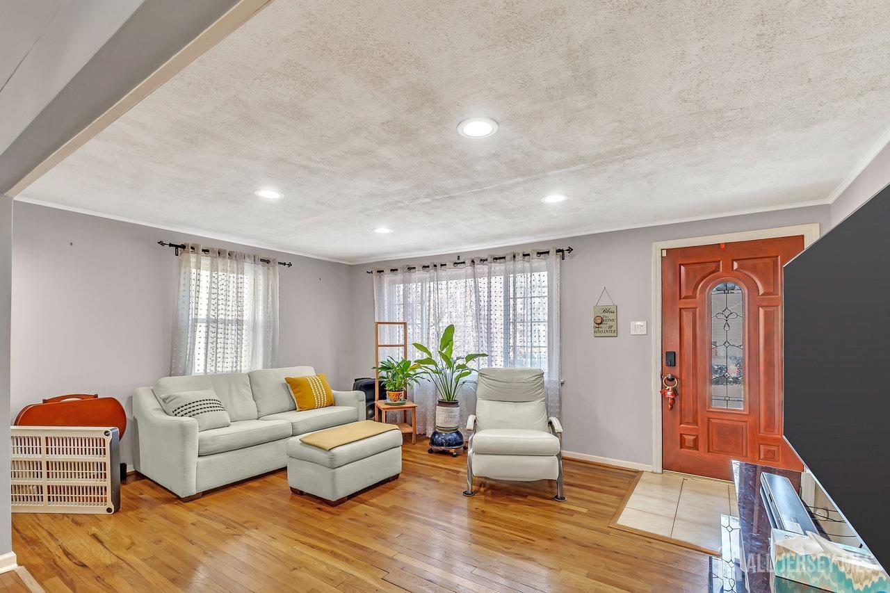 123 Highfield Road Colonia, NJ 07067 - Photo 6 of 30 a living room with furniture and wooden floor