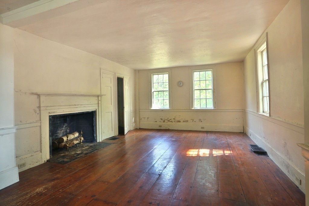 82 Baldpate Road Boxford, MA 01921 - Photo 8 of 20 a view of an empty room with wooden floor fireplace and a window