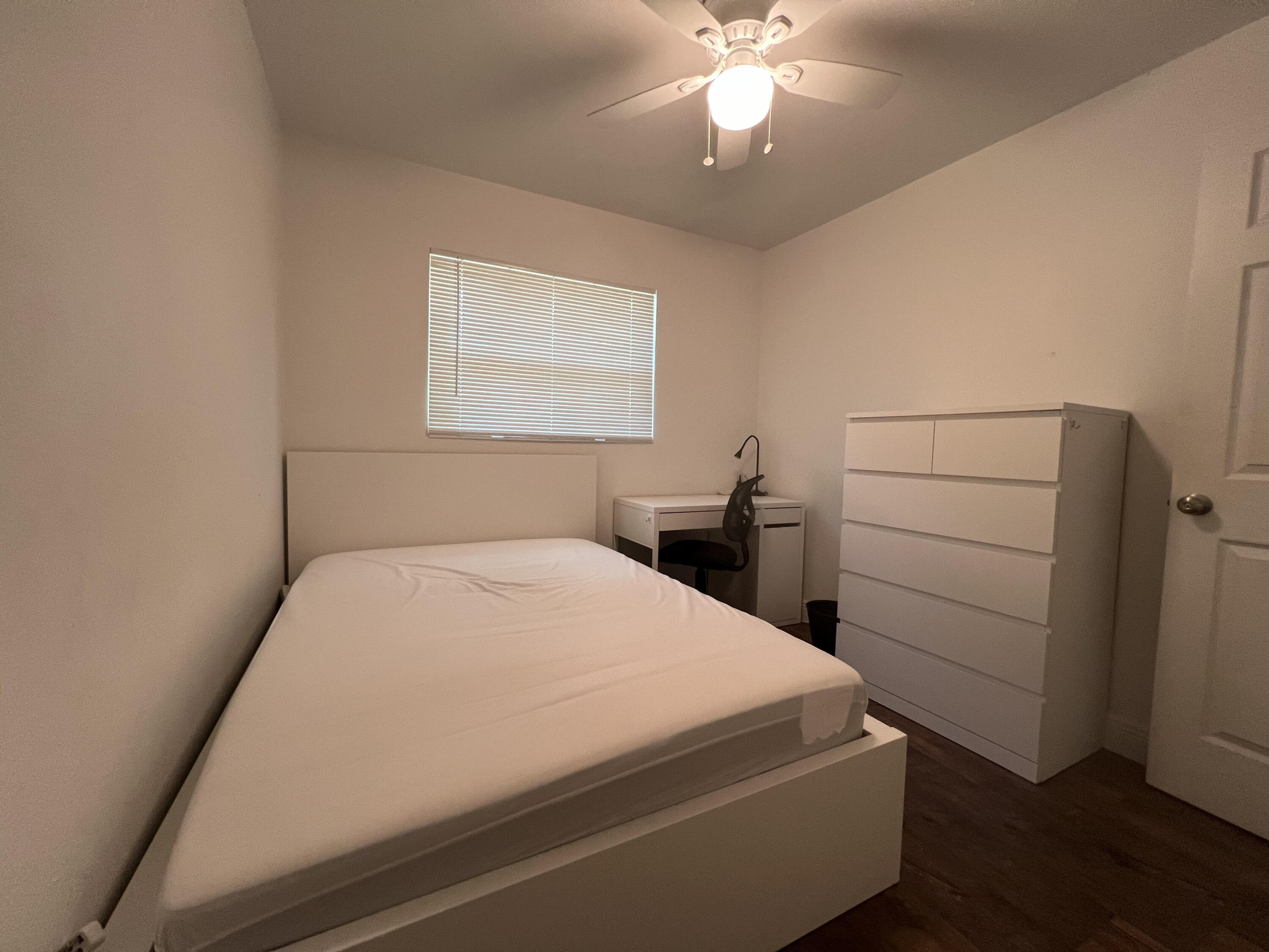 2807 South Vassar Street Melbourne, FL 32901 - Photo 11 of 12 a bedroom with a bed and a chandelier