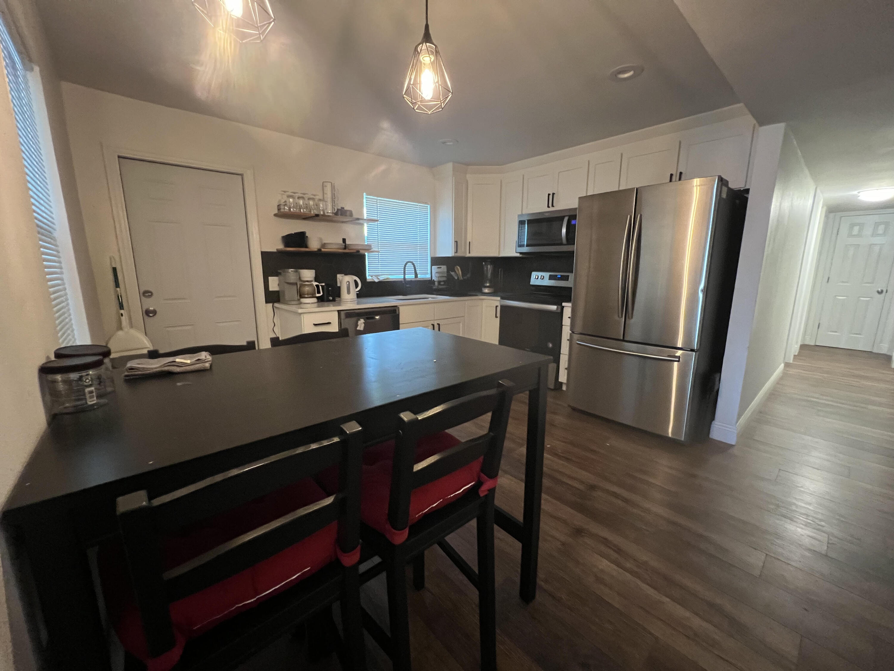 2807 South Vassar Street Melbourne, FL 32901 - Photo 5 of 12 a kitchen with a refrigerator a sink dishwasher a stove and a refrigerator with wooden floor