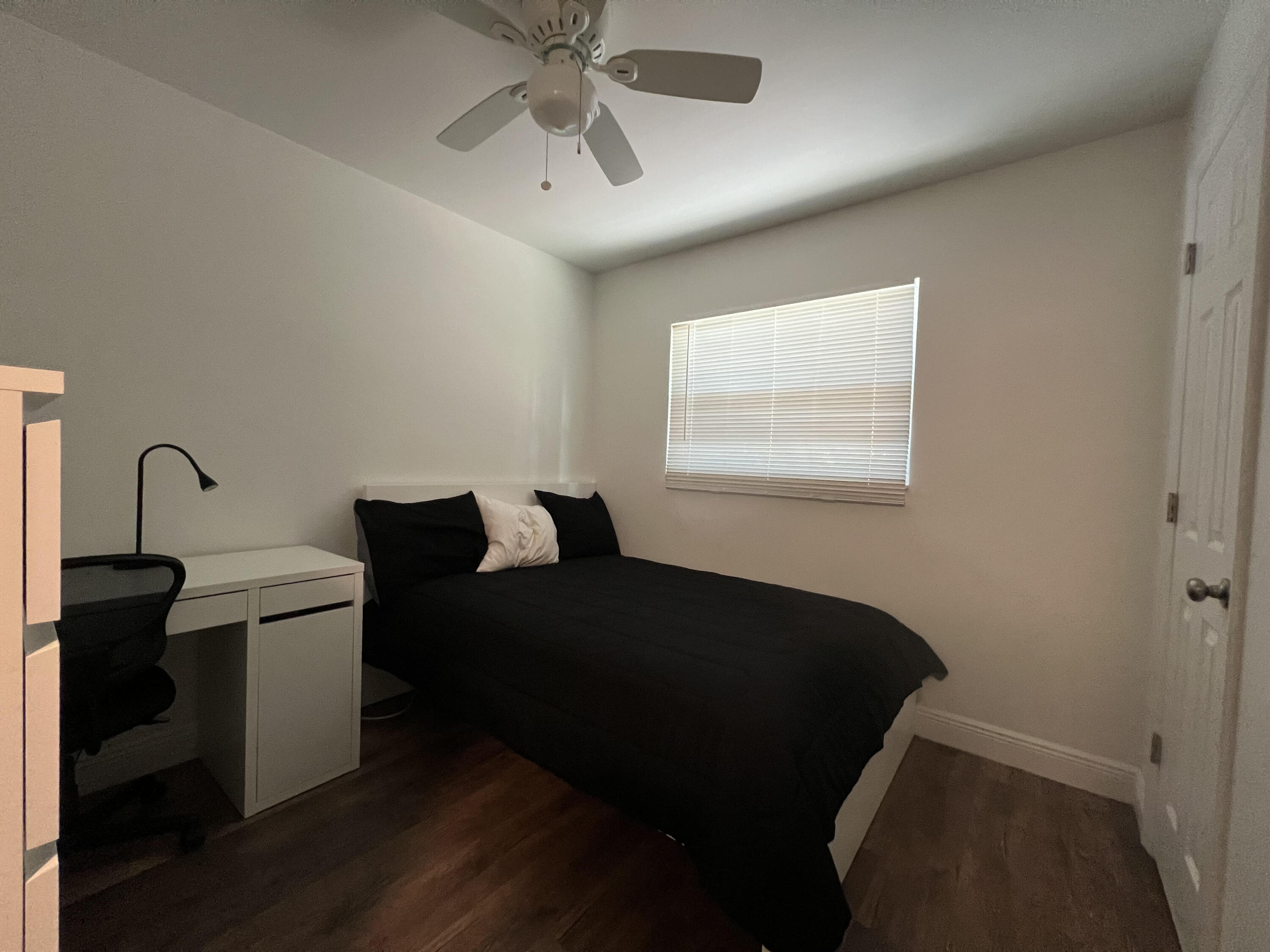 2807 South Vassar Street Melbourne, FL 32901 - Photo 8 of 12 a bedroom with a bed and wooden floor