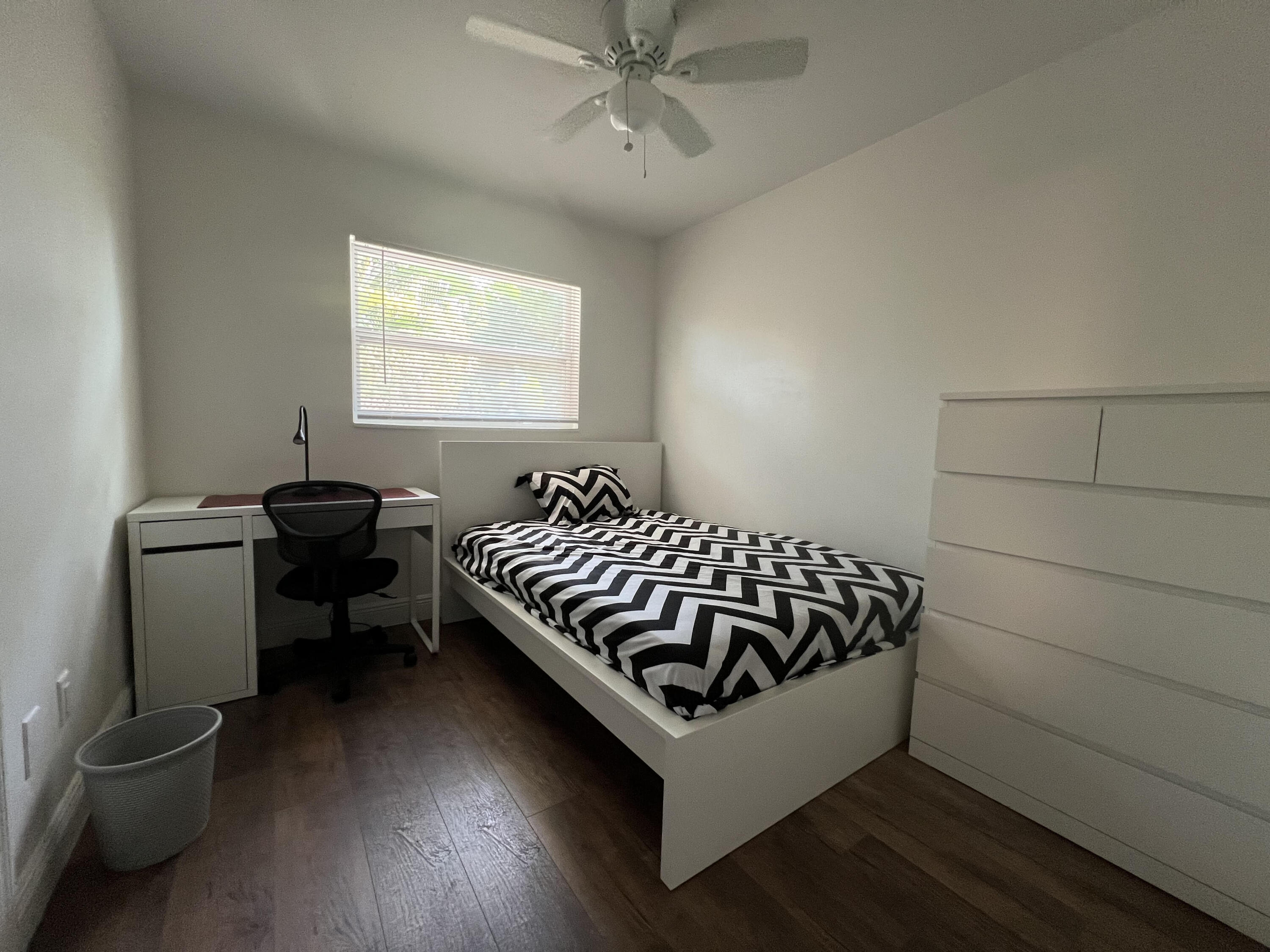 2807 South Vassar Street Melbourne, FL 32901 - Photo 9 of 12 a bedroom with a bed and wooden floor