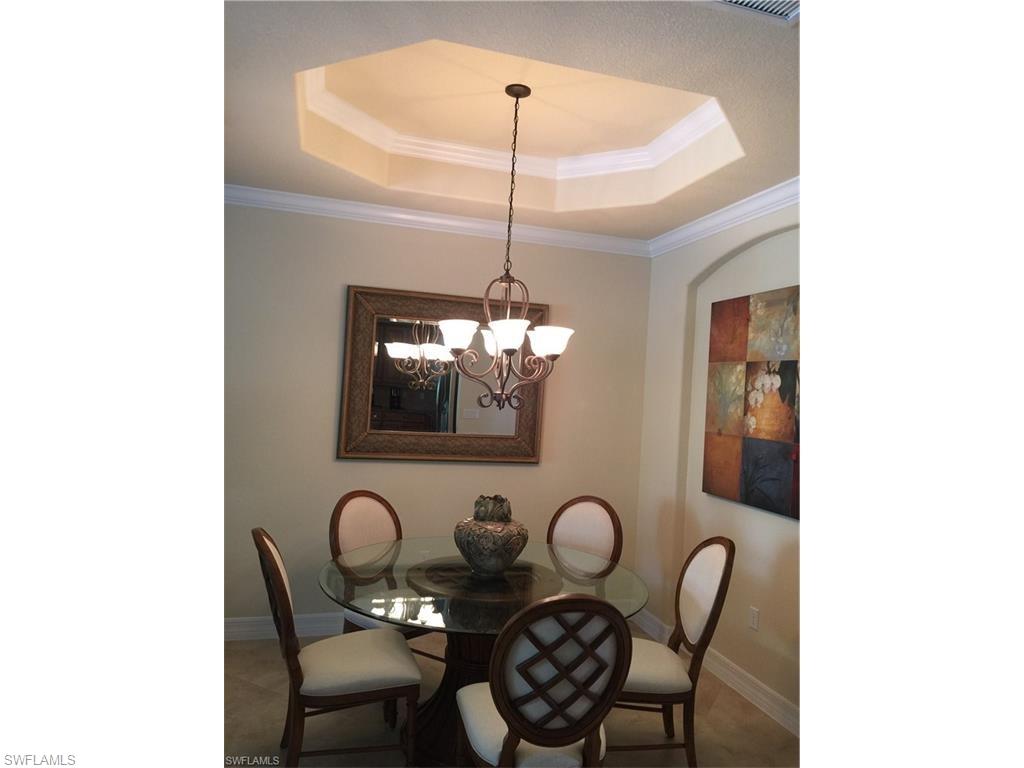 9471 Piacere Way Naples, FL 34113 - Photo 7 of 22 a dining room with furniture and chandelier