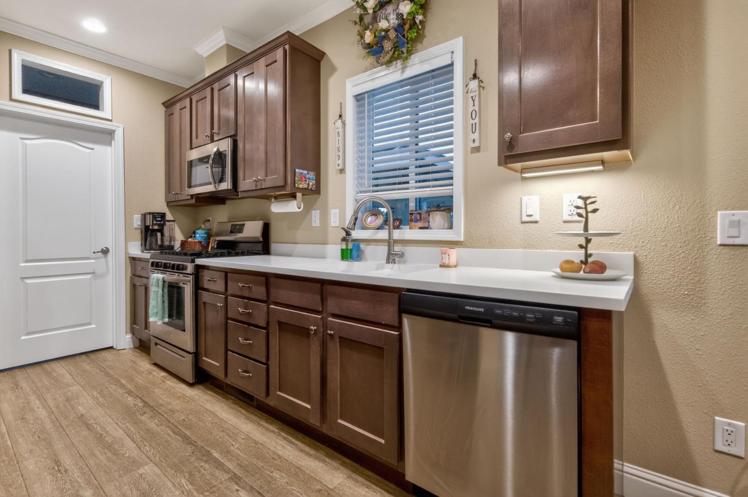 7570 Airola Road Vallecito, CA 95251 - Photo 66 of 90 a kitchen with a sink wooden cabinets and stainless steel appliances