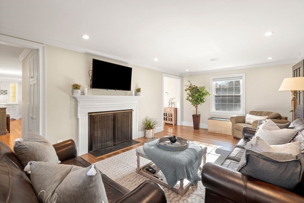 20 Shetland Road Marblehead, MA 01945 - Photo 20 of 40 a living room with furniture a fireplace and a flat screen tv
