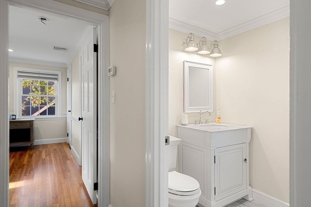 20 Shetland Road Marblehead, MA 01945 - Photo 32 of 40 a bathroom with a sink a toilet a large mirror and shower
